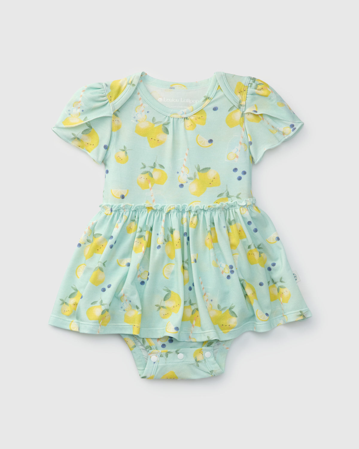 Children's baby girl bodysuit dress outfit with lemon pattern on a light green background