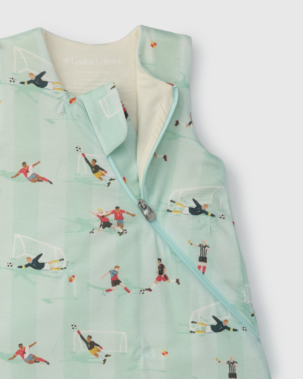 Children's sleep bag with soccer pattern on a light gray background