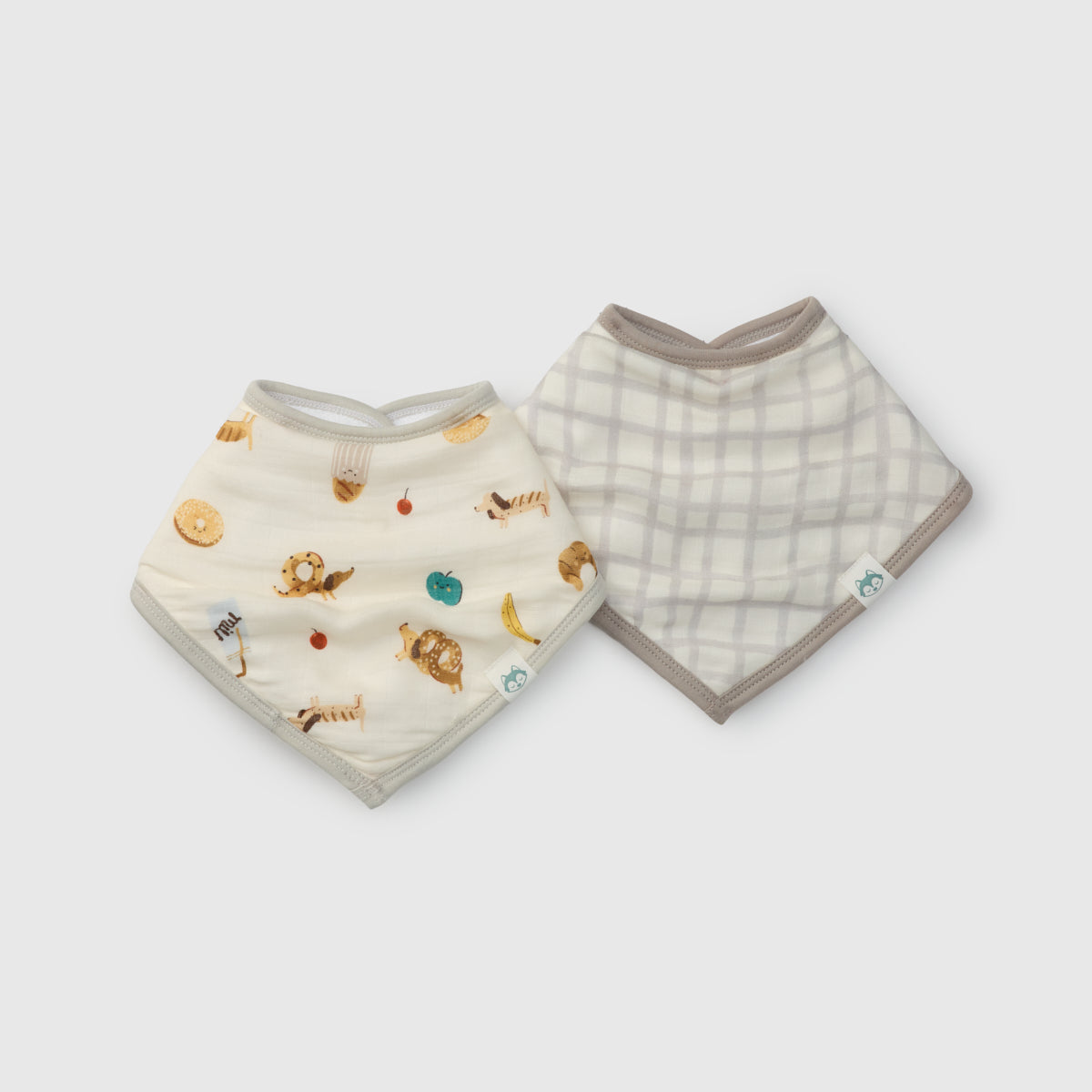 Two baby bibs with different patterns on a white background