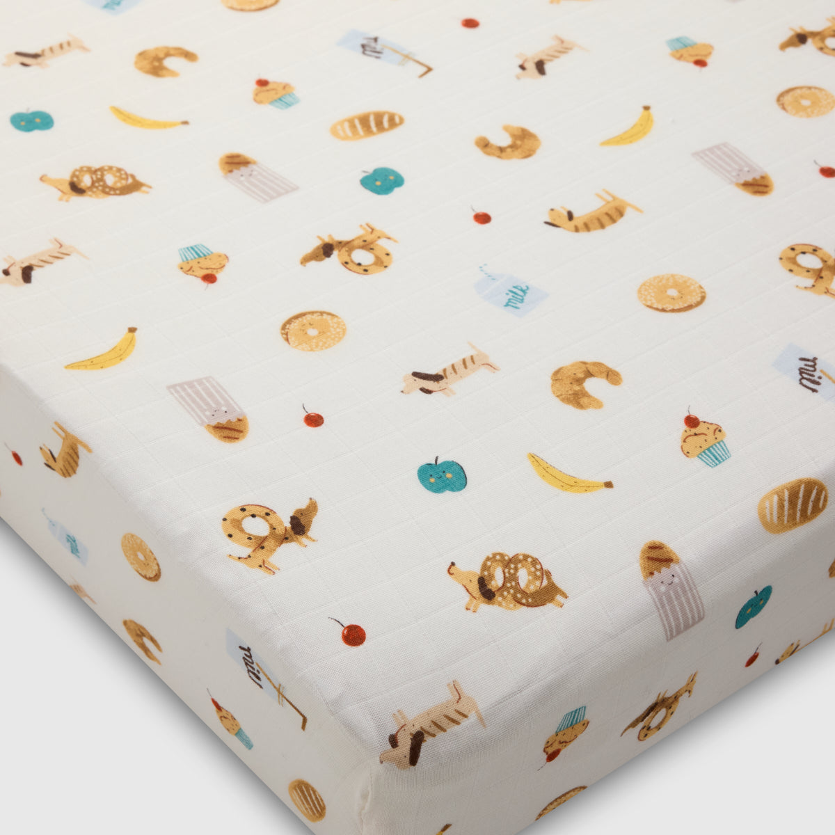 Fitted crib sheet with animal pattern on a white background