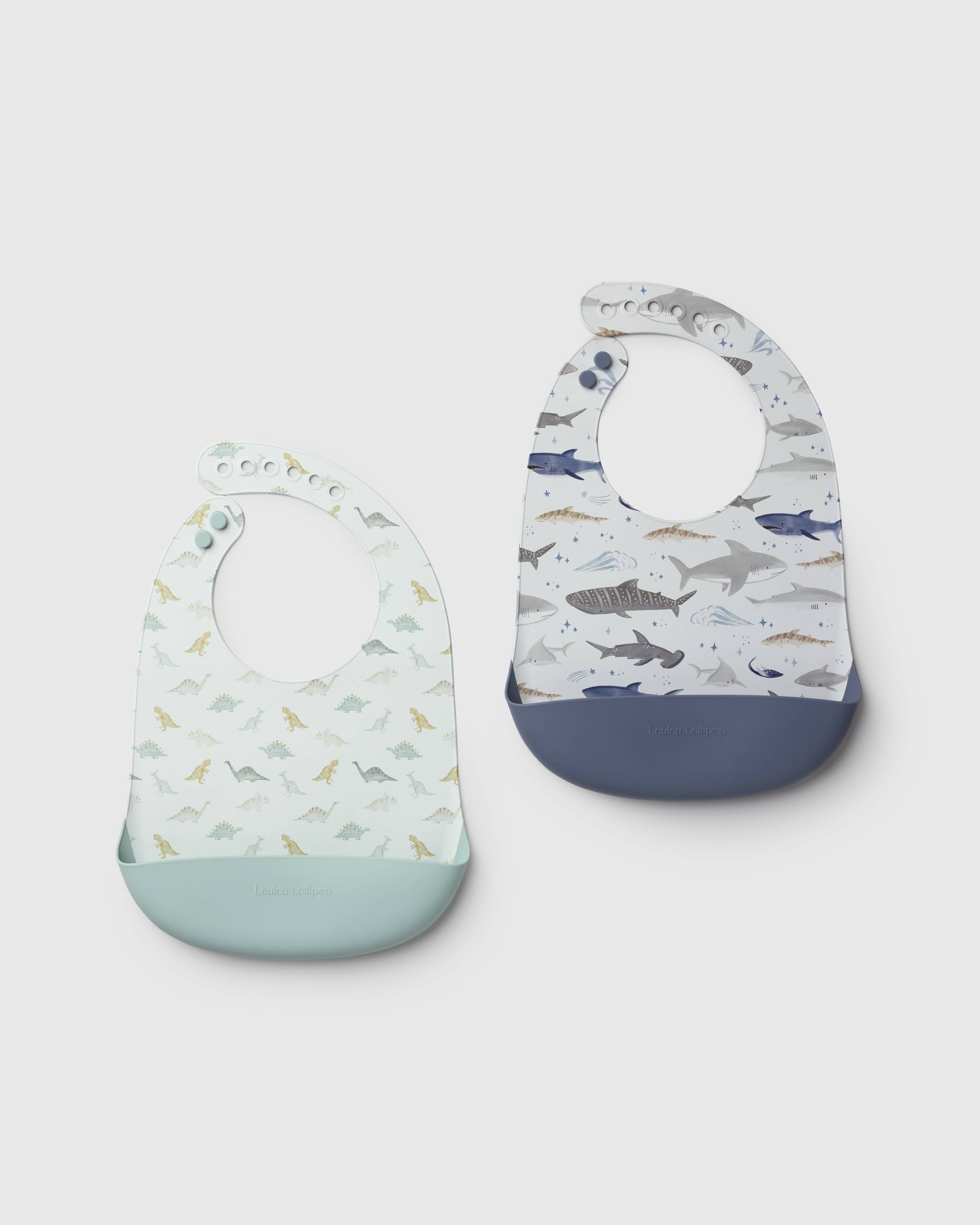 Loulou Lollipop FDA-compliant food-grade silicone baby bib set in Smiley Sharks and Dinosaurs and Neutral Checkerboard - front view on white background