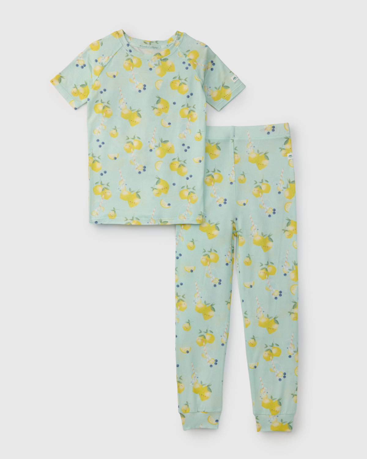 Children's pajama set with lemon pattern on a light blue background