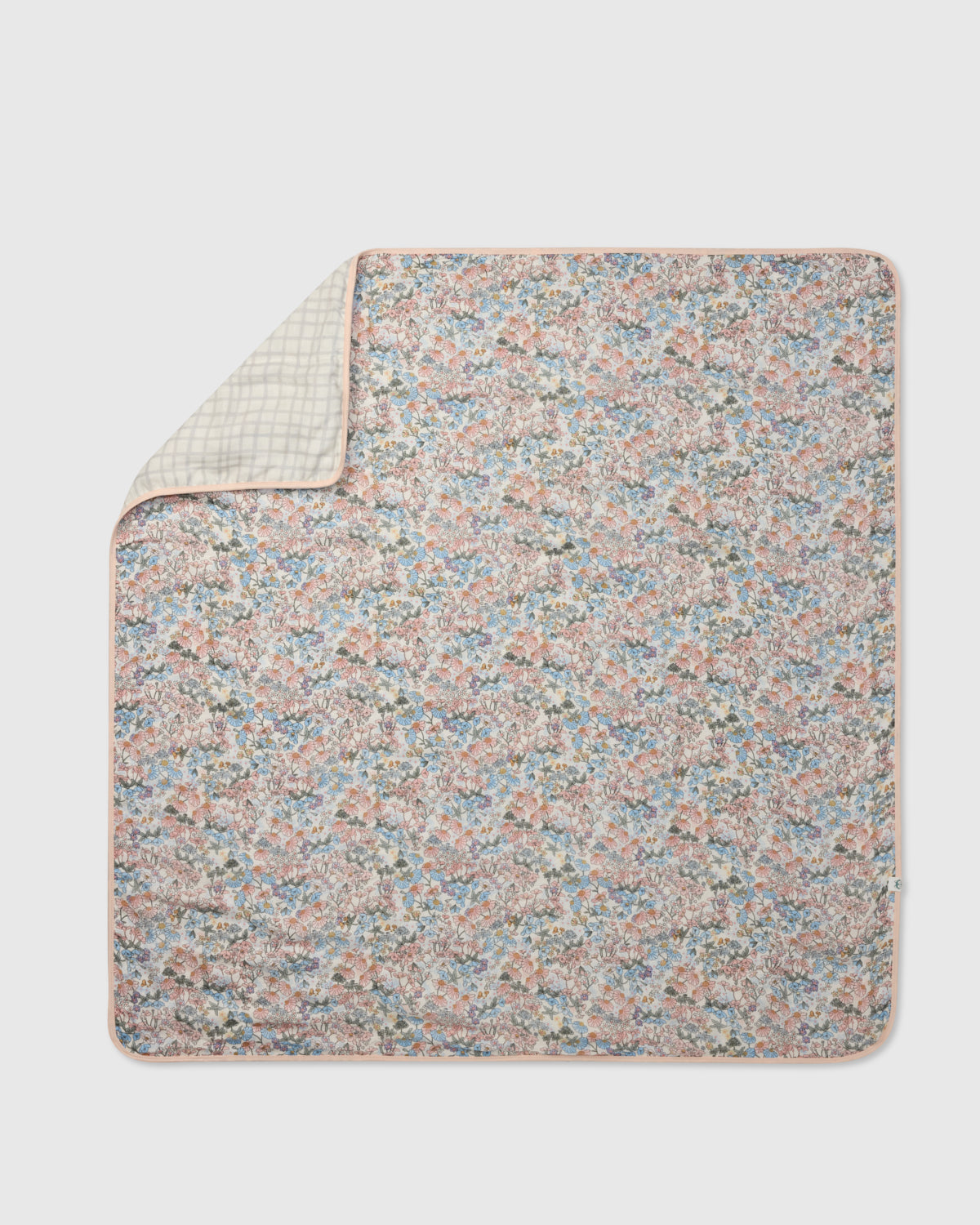 Floral patterned blanket on a light gray background