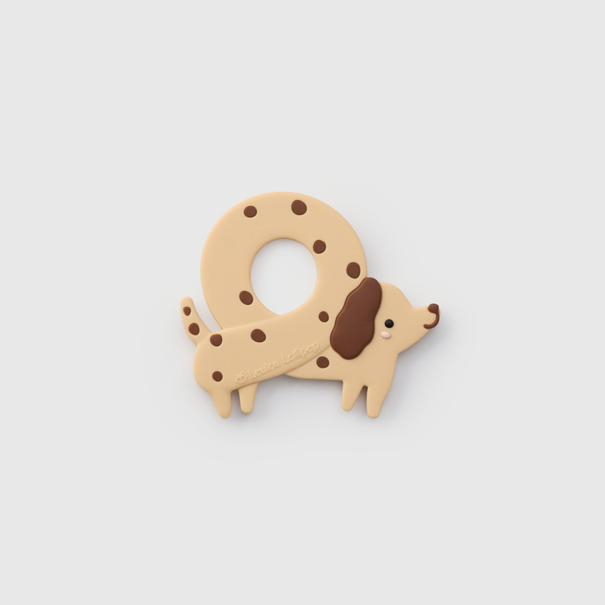Dog-shaped teether with brown spots on a light gray background
