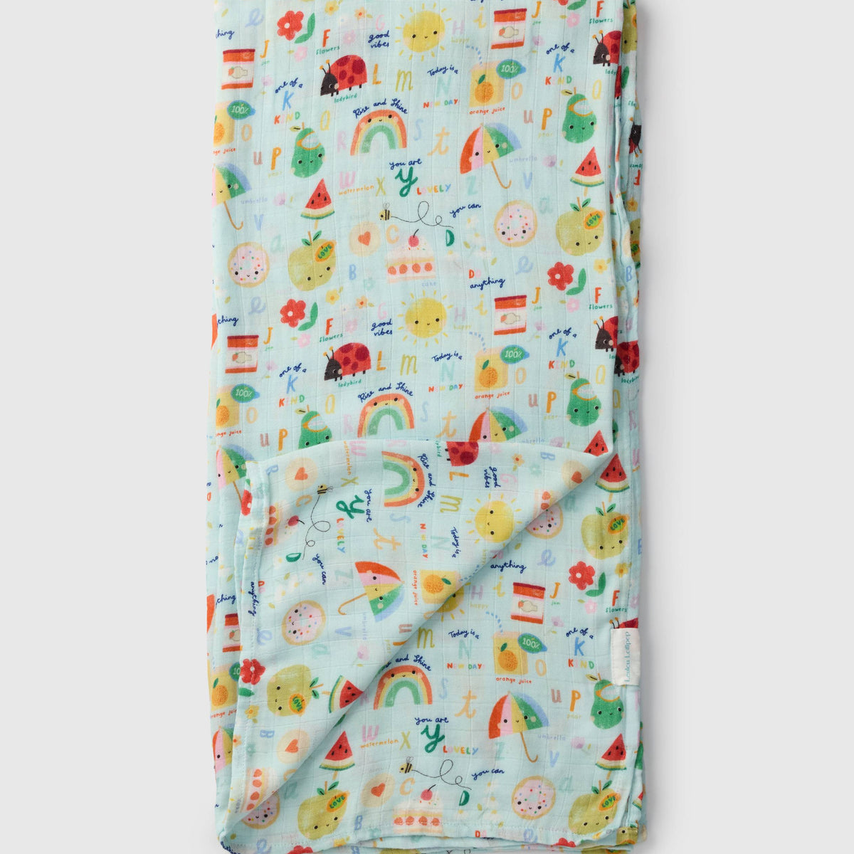 Loulou Lollipop bamboo cotton muslin swaddle blanket in Alphabet Smiles — front view on white background