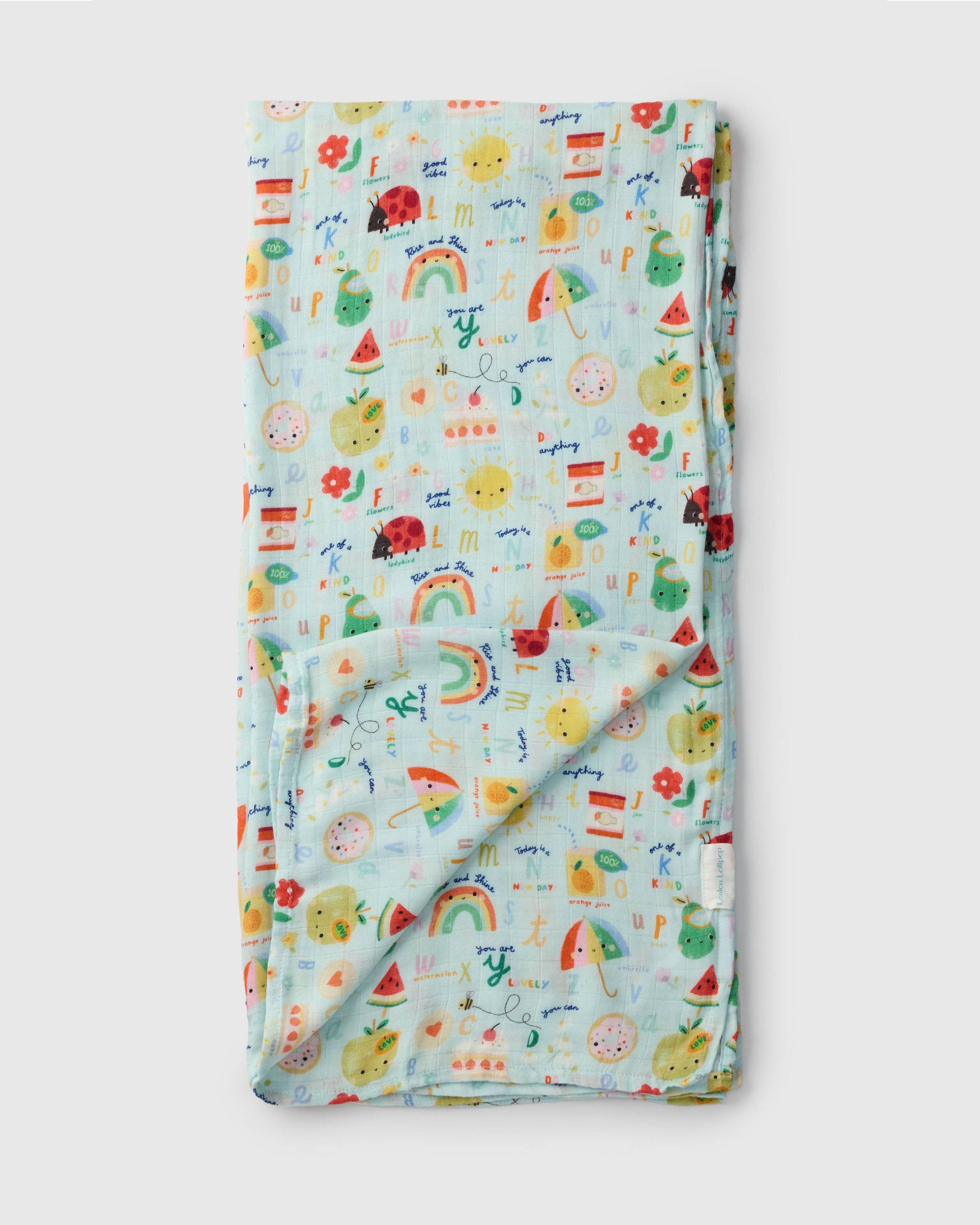 Loulou Lollipop bamboo cotton muslin swaddle blanket in Alphabet Smiles — front view on white background