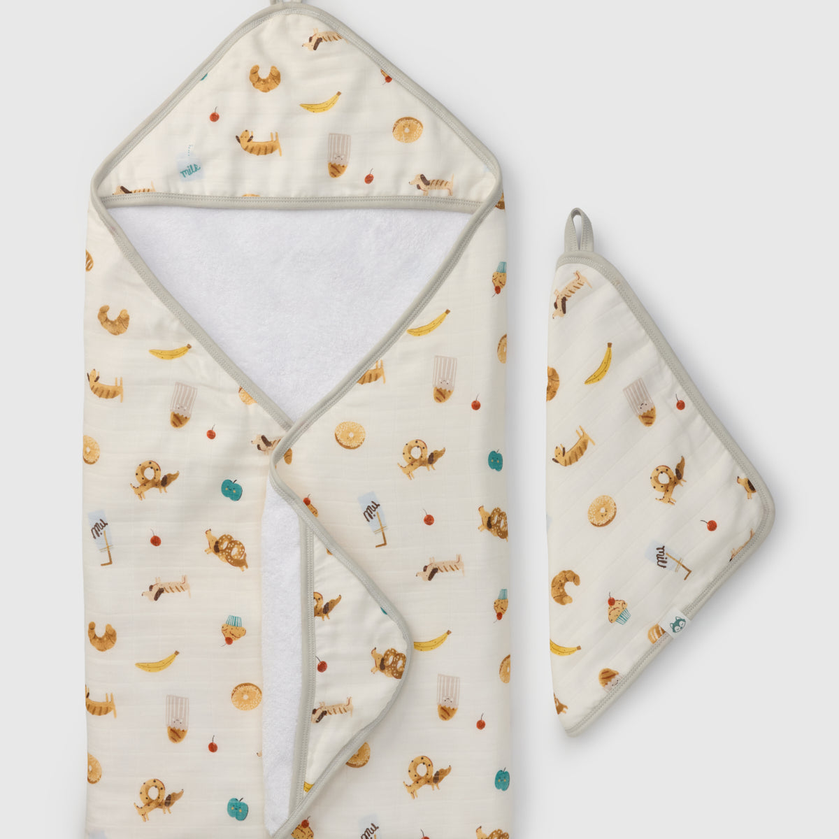 Hooded baby towel with food themed animal pattern on a white background