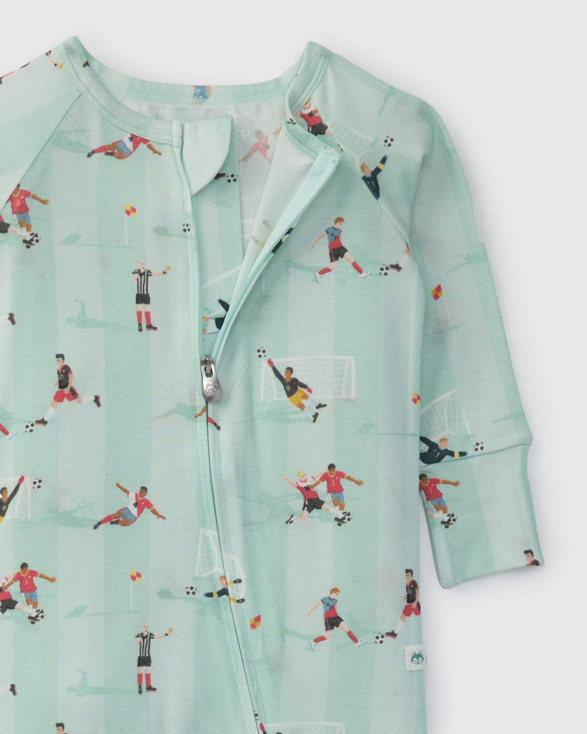 Light blue baby romper with soccer-themed print on a white background