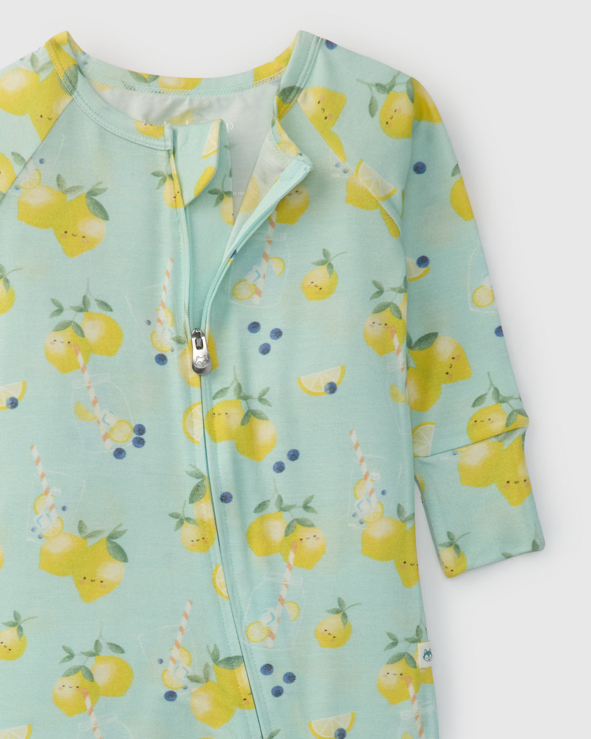 Children's onesie with lemon pattern on a light green background
