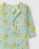 Children's onesie with lemon pattern on a light green background