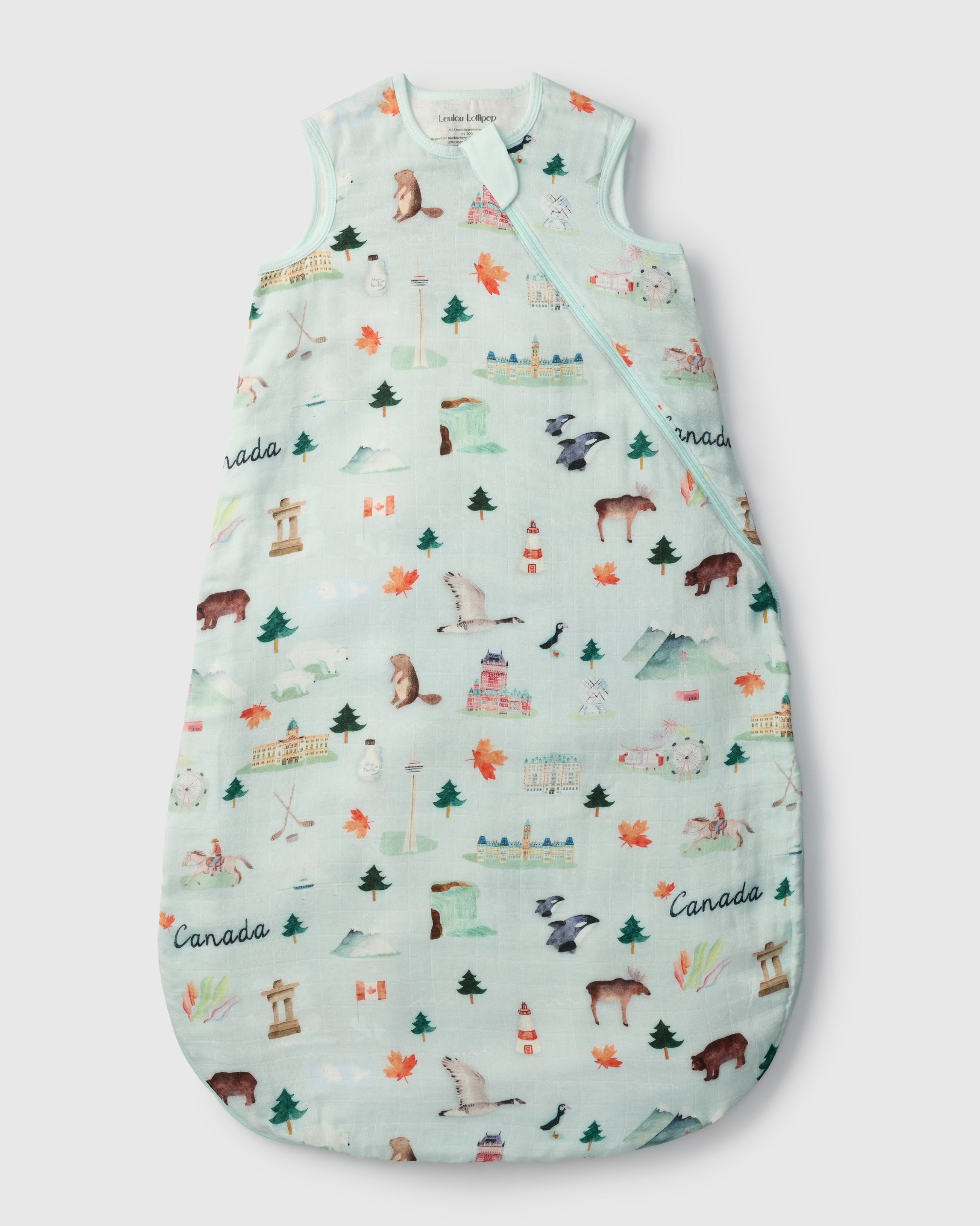 Baby sleeping bag with nature-themed print on a light blue background