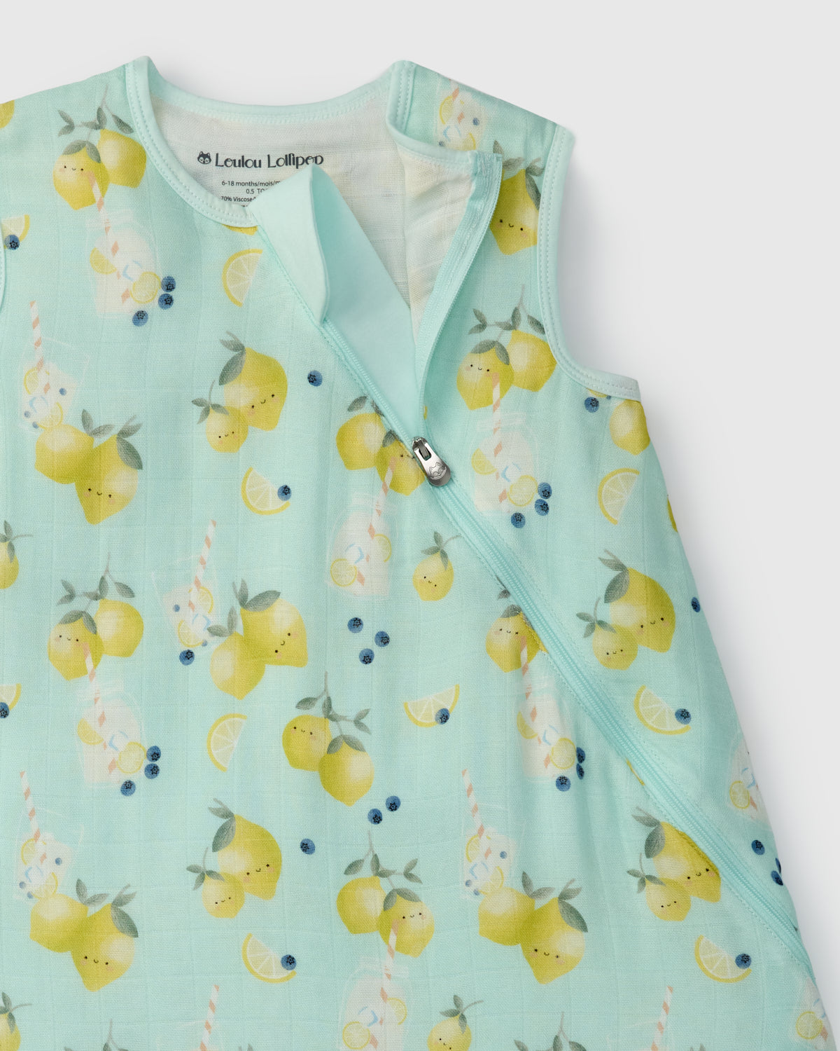 Light blue baby sleep bag with lemon pattern on a white background