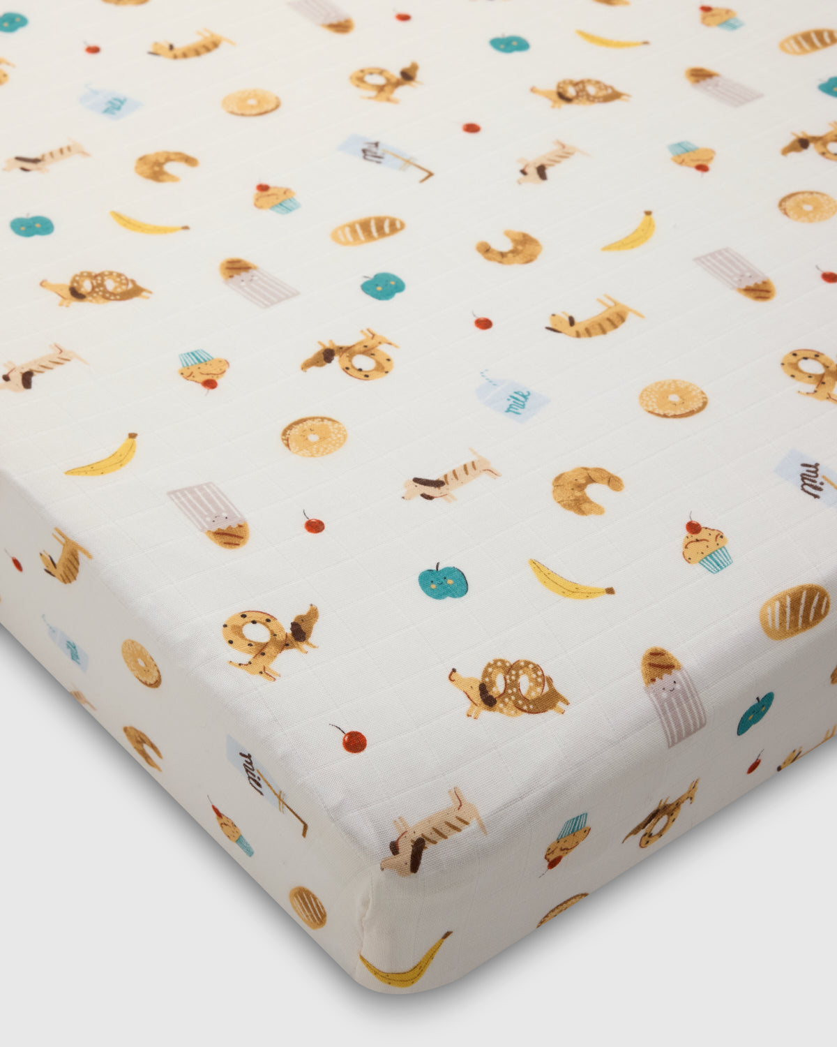 Fitted crib sheet with animal pattern on a white background