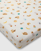 Fitted crib sheet with animal pattern on a white background