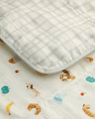 Baby blanket with animal pattern on a plain background