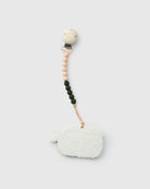 Teething ring with silicone strap on a white background