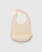 Beige baby bib on a light gray background