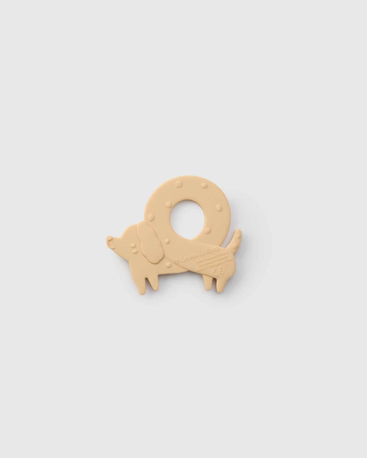 Beige teething ring with pretzel dog design on a light gray background