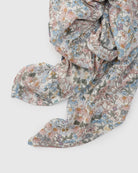 Floral patterned fabric muslin swaddle on a white background