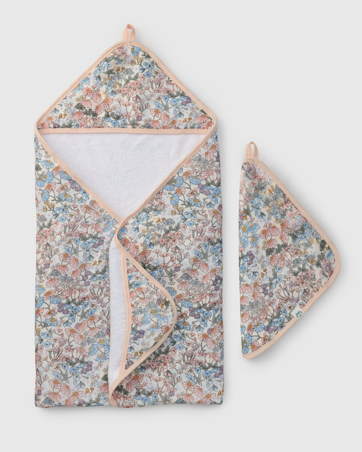 Floral-patterned towel set with a hood and matching pot holder on a light gray background